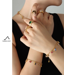 Detailed view of gold stainless steel jewelry set with colorful zircon gemstones