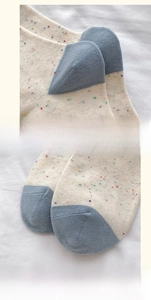 Detailed macro view of reinforced heel and flat toe seams on beige cotton blend socks