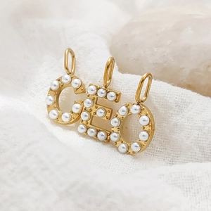 Detailed view of 14K gold pearl letter pendants C E O for DIY jewelry
