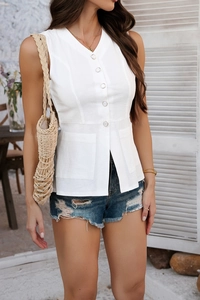 Detail of white V-neck sleeveless top featuring functional buttons and side patch pockets
