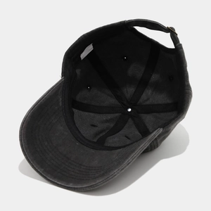 Detail view of washed cotton baseball cap featuring inner sweatband and metal buckle