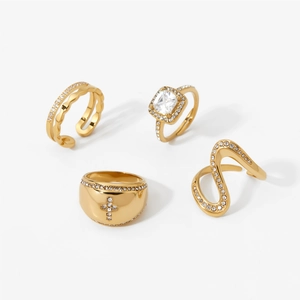 Golden stainless steel irregular ring set with sparkling zirconia on white background