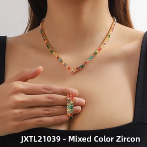 Detail of V-shaped gold necklace and ring set with colorful square-cut zircon stones