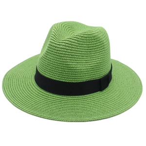Close-up of bright green Panama hat with black grosgrain ribbon and fine weave detail
