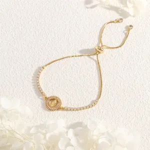 Detail of 18K gold adjustable bracelet with Virgin Mary pendant and sparkling zircon