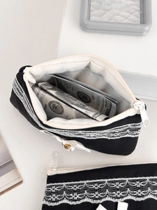 Black fabric coin purse with white lace trim and pearl zipper puller for women