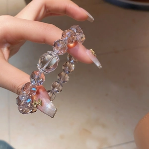 Detail of faceted crystal beads and large round transparent center stone on the bracelet