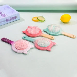 Detail view of four cute cat-ear hairbrushes in pastel gradient colors with lemon accents