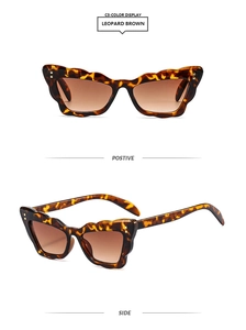 Detail of leopard brown cat eye sunglasses with butterfly frame and metal dot accents