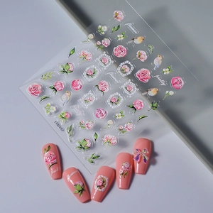 Detail of 3D embossed floral nail stickers featuring pink roses and bird patterns on nails