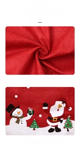 Detail of thick red non-woven Christmas chair cover with festive cartoon character print