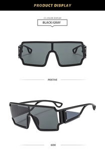 Front and side view of black hollow punk oversized shield sunglasses with gray lenses