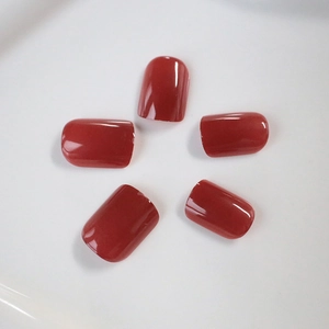 Short square press-on nails in deep red jelly color with high-gloss glazed finish
