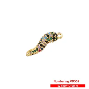 Detail view of colorful S-shaped chili pendant with vibrant cubic zirconia and gold plating