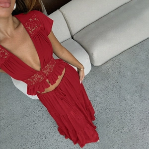 Détail d'un ensemble rouge en dentelle avec col en V et jupe longue au design élégant