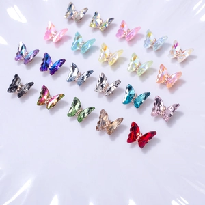 Detailed array of 3D crystal butterfly nail charms in various vibrant aurora colors