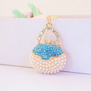 Creative handbag keychain with blue rhinestones and white pearls on gold metal plating