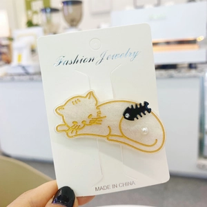 Cute acetate cat hair clip in milky white with gold accents and a pearl detail