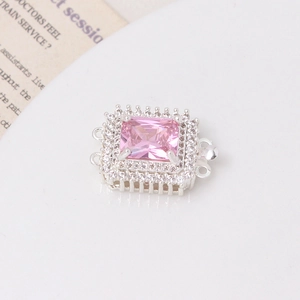 Macro detail of silver square clasp featuring a large pink gemstone and pavé zircon accents