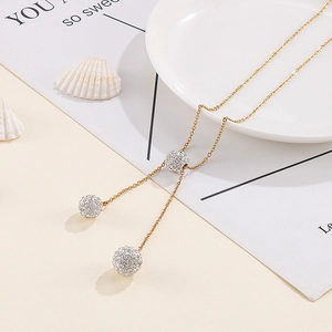 Elegant gold necklace with three sparkling crystal-studded spheres and thin chain