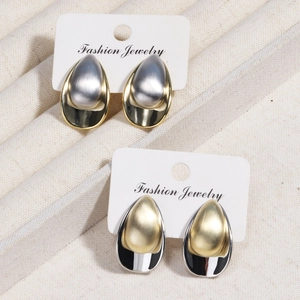 Minimalist gold and silver two-tone teardrop earrings with brushed metal texture