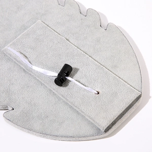 Detail of grey velvet necklace display with white ribbon and secure black plastic buckle