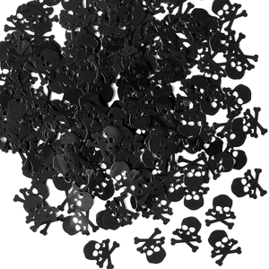 Close-up of black skull and crossbones confetti for Halloween party decoration