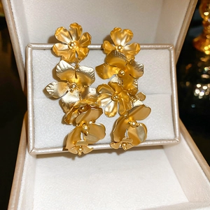 Exquisite gold floral drop earrings with rhinestones displayed in a premium jewelry box