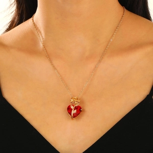 Gothic rose heart pendant necklace with red gem on gold chain shown on neck
