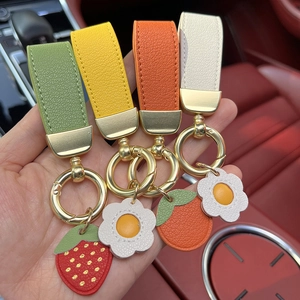 Set of four colorful leather car keychains with cute fruit and flower charms