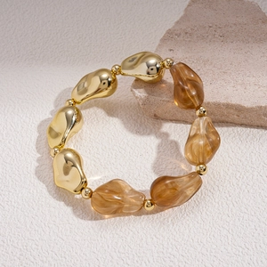 Détail du bracelet bohème avec perles irrégulières en acrylique ambre et métal doré