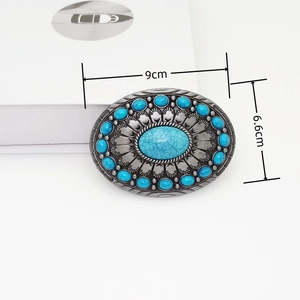 Detail view of oval silver belt buckle showing 9cm width and 6.6cm height measurements