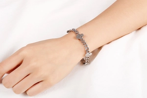 Detailed view of silver pineapple charm bracelet on wrist with high quality metal finish