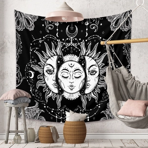 Detailed view of sun and moon tapestry in a cozy bohemian room with hammock chair