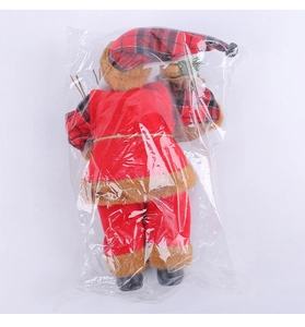 Detail of Santa Claus figurine with red plaid hat and gift sack in protective packaging