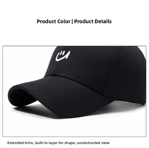 Detail of embroidered smile logo on a black cotton baseball cap with curved brim