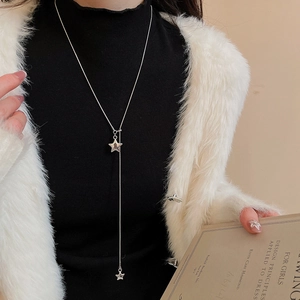 Silver double star pendant fringe necklace shown on model wearing black turtleneck