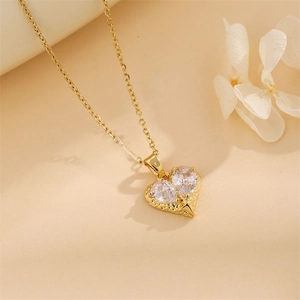 Elegant gold heart pendant with sparkling crystals and star detail on warm background