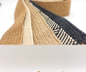 Detail of multi-colored woven straw belts featuring natural raffia texture and earthy tones