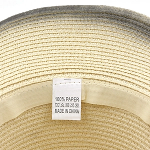 Close-up of western cowboy straw hat interior with 100% paper material label