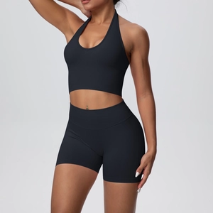 Detail of black halter neck yoga top and high waist ribbed seamless sports shorts set