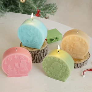 Close-up of four embossed Christmas candles featuring Santa and snowman icons