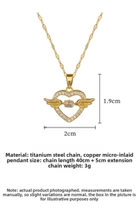 Detailed close-up of golden heart angel wings necklace with sparkling zircon stone