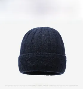 Detailed front view of a navy blue knitted wool beanie featuring a small metallic logo
