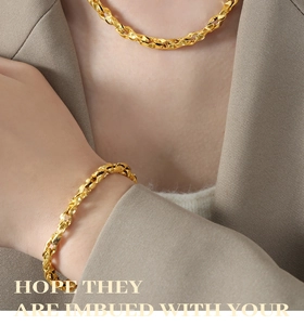Detailed view of polished gold plated thick woven chain necklace and bracelet set