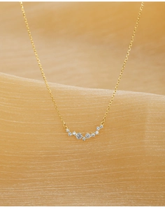 Macro shot of 18K gold plated silver necklace with sparkling cubic zirconia star pendant