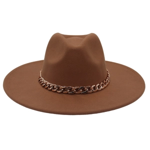 Detail of a brown wide-brim fedora hat featuring a chunky gold acrylic chain decoration