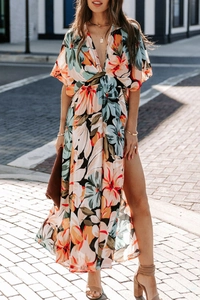 Detail of V-neck floral maxi dress with side slit and bohemian print in orange and blue