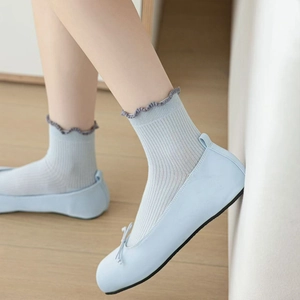 Light blue ballet flats with matching ruffled crew socks and delicate bow detail