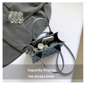 Top view of denim handbag interior showing storage capacity for phone and cosmetics
